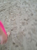 Foot walking on sand